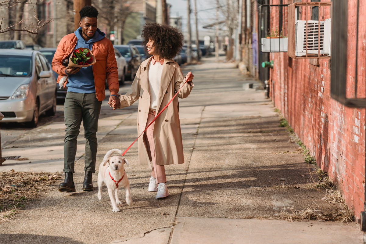 Black couple walking with adorable pet